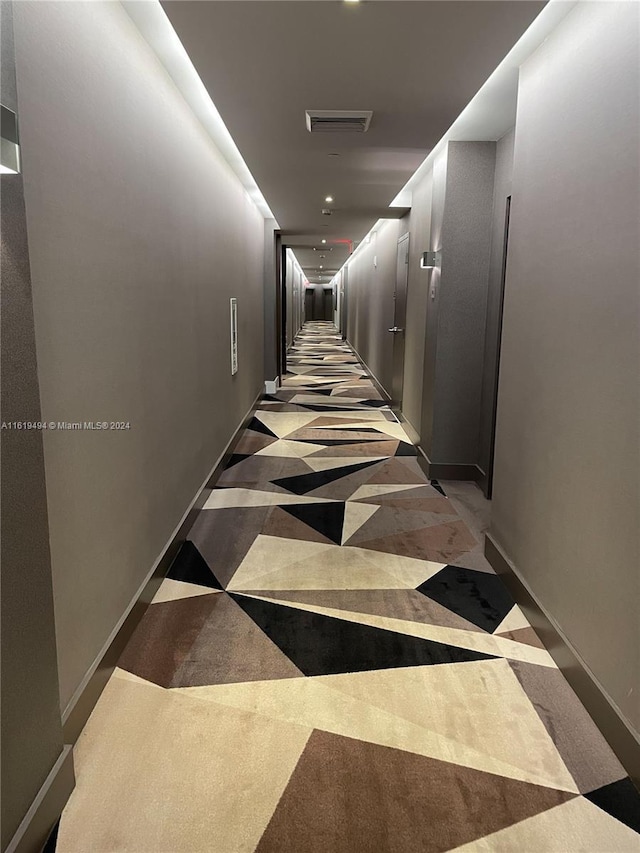 corridor featuring visible vents and baseboards