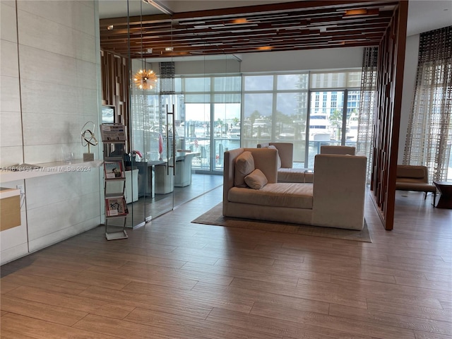 unfurnished living room with wood finished floors and a notable chandelier