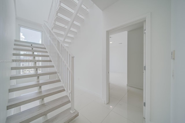 stairs featuring light tile patterned floors