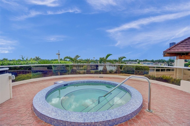 view of pool with an in ground hot tub