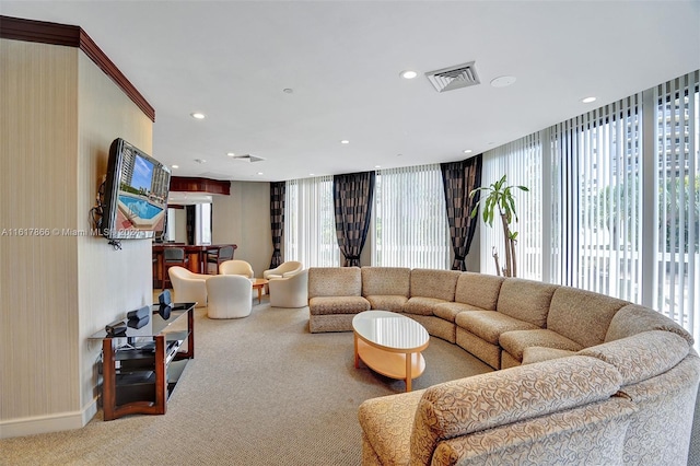 living room featuring a wall of windows, a wealth of natural light, and carpet flooring