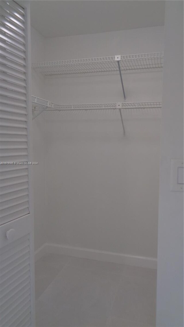 spacious closet featuring tile patterned floors