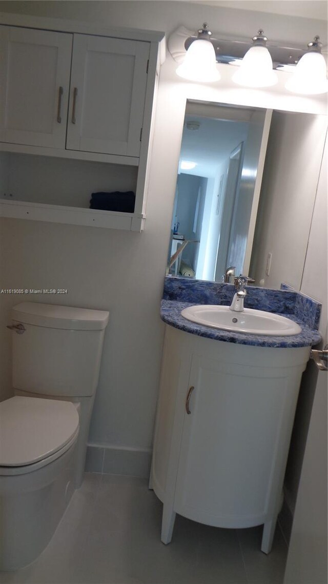 bathroom featuring toilet and vanity