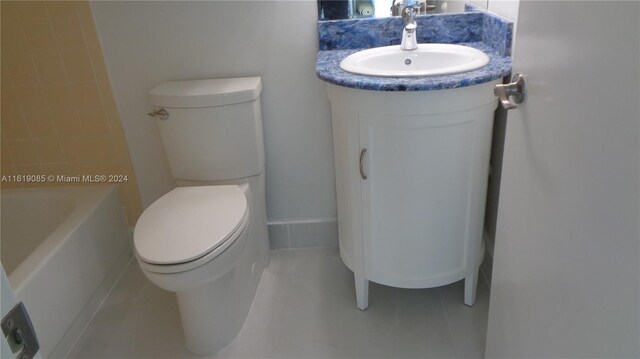 bathroom featuring vanity, tile patterned flooring, and toilet