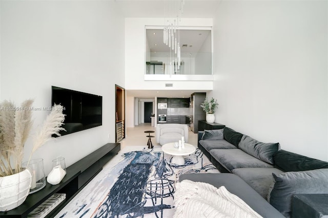 living room featuring visible vents and a towering ceiling