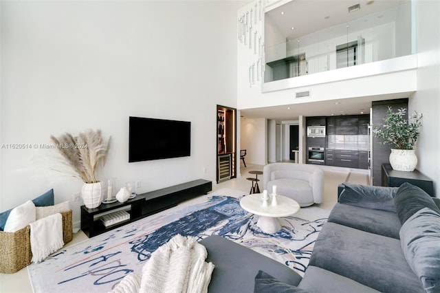 living room featuring visible vents and a high ceiling