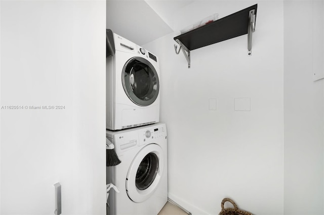 laundry room featuring laundry area and stacked washer / drying machine