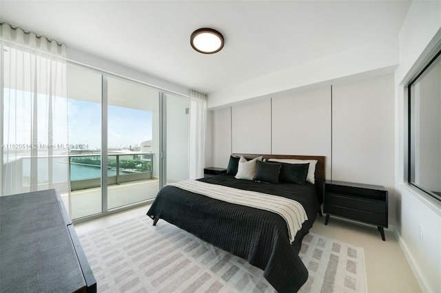 bedroom featuring access to exterior and baseboards