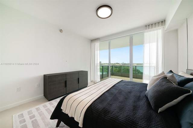 bedroom featuring light colored carpet and baseboards