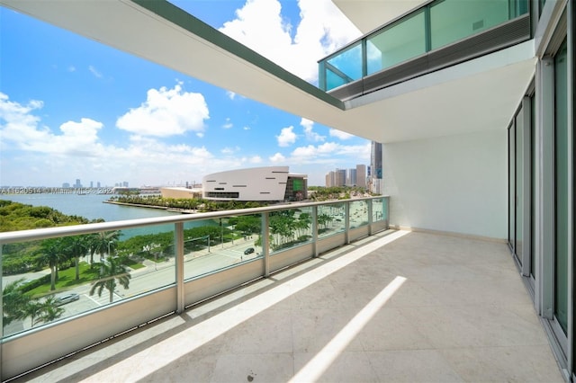 balcony with a view of city, central AC, and a water view