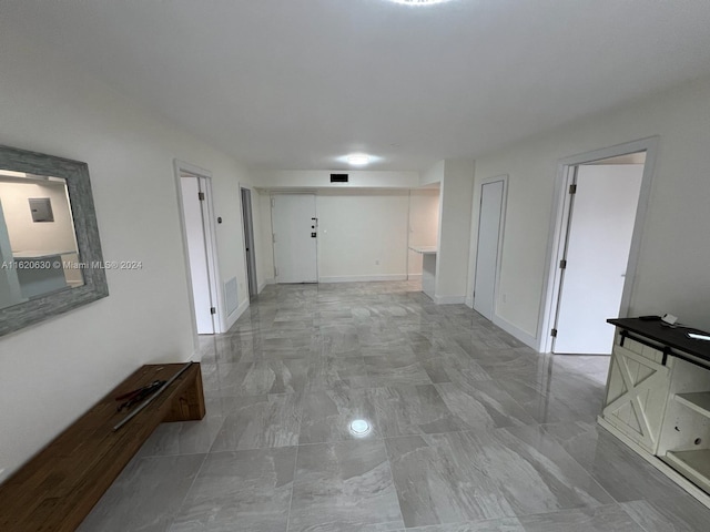 hall featuring light tile patterned flooring