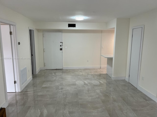 empty room with visible vents and baseboards