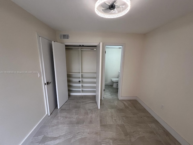 interior space featuring baseboards, visible vents, and a closet