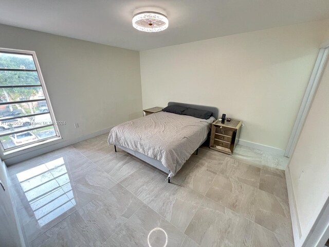 bedroom with light tile patterned floors