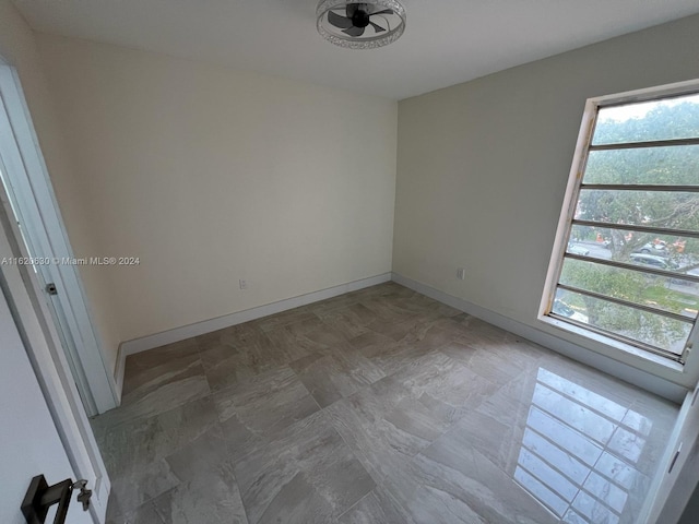 unfurnished room featuring baseboards