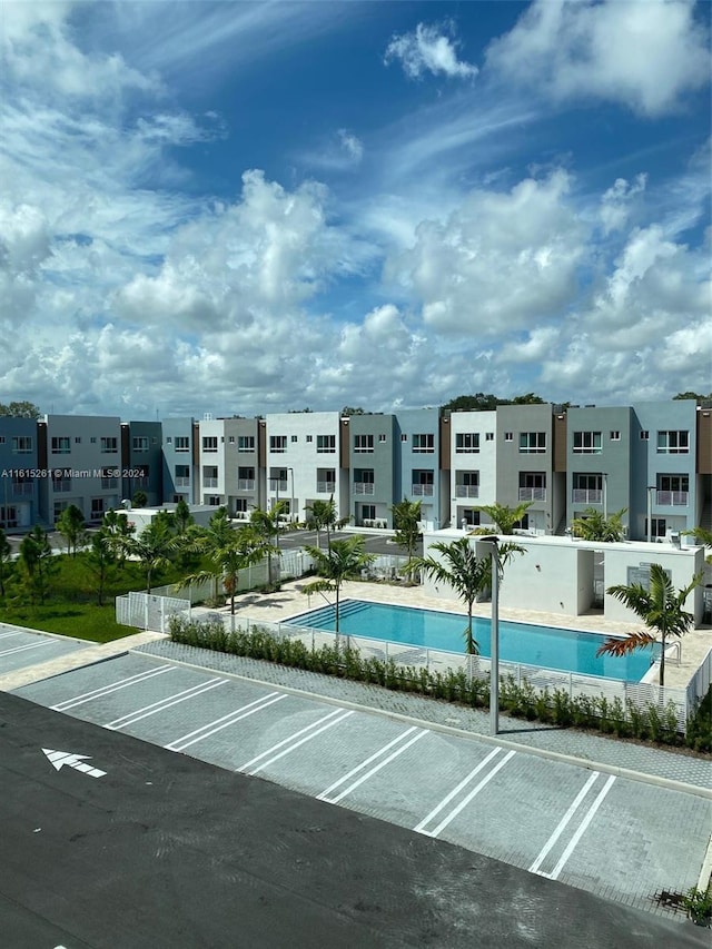 view of parking / parking lot with a community pool