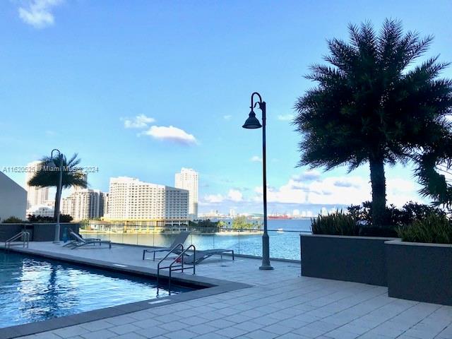 view of swimming pool featuring a water view