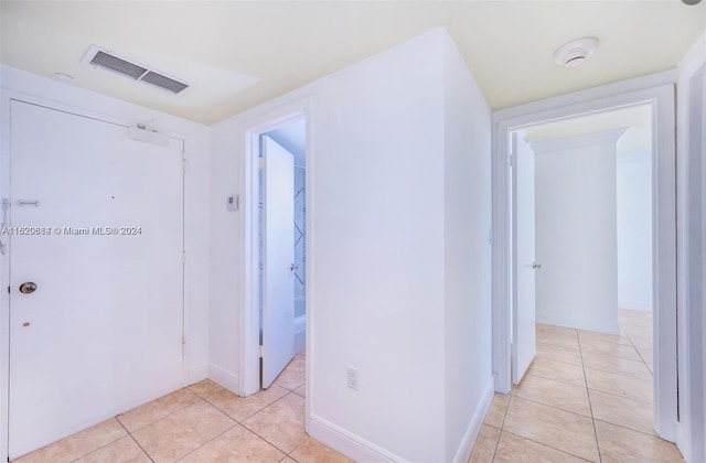 corridor featuring light tile patterned floors