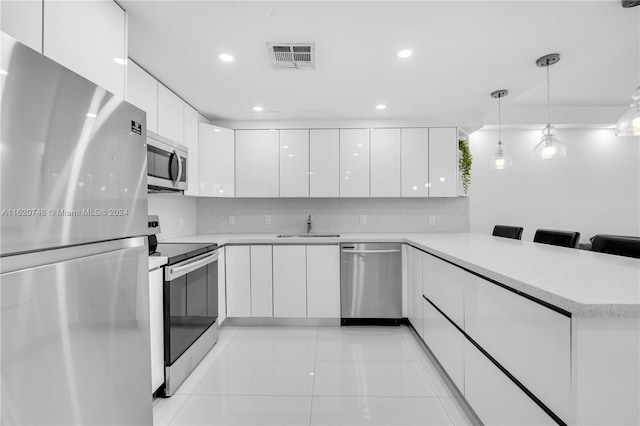 100 Bayview Dr Unit 430, Sunny Isles Beach, FL 33160 - kitchen featuring appliances with stainless steel finishes, modern cabinets, white cabinetry, a peninsula, and recessed lighting