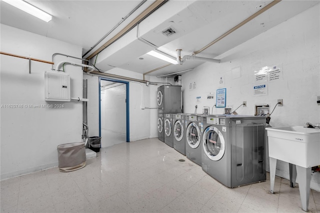 laundry room with stacked washer / dryer, separate washer and dryer, and electric panel