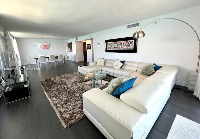 living room with dark hardwood / wood-style flooring