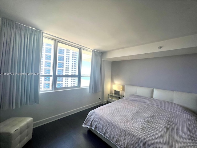 bedroom with dark hardwood / wood-style floors