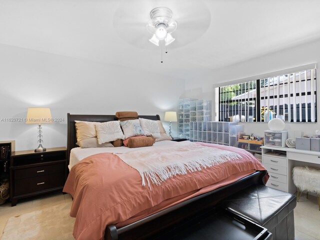 bedroom with ceiling fan and light tile patterned floors