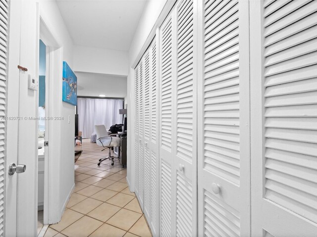 corridor featuring light tile patterned floors