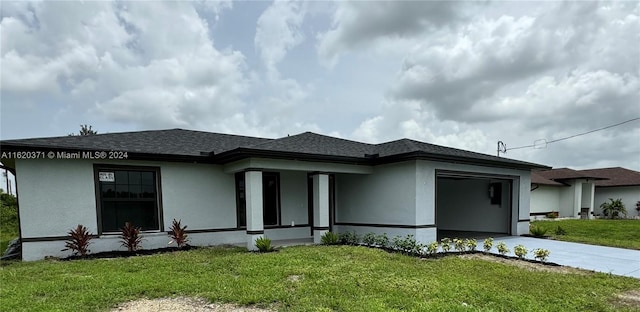 prairie-style house featuring a garage, a front yard, and central AC unit