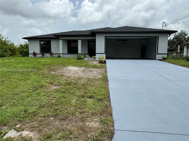 view of front of house featuring a front yard and a garage