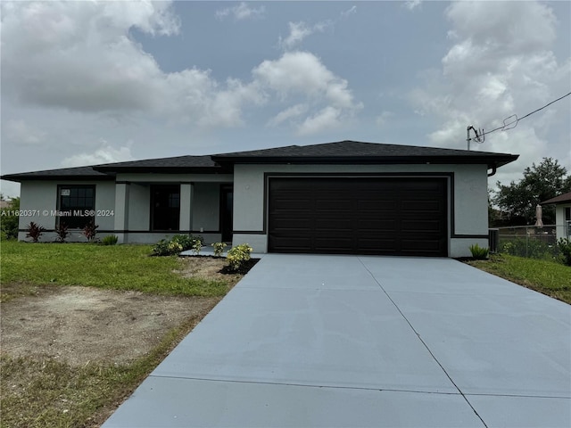 view of front of house with a front lawn and a garage