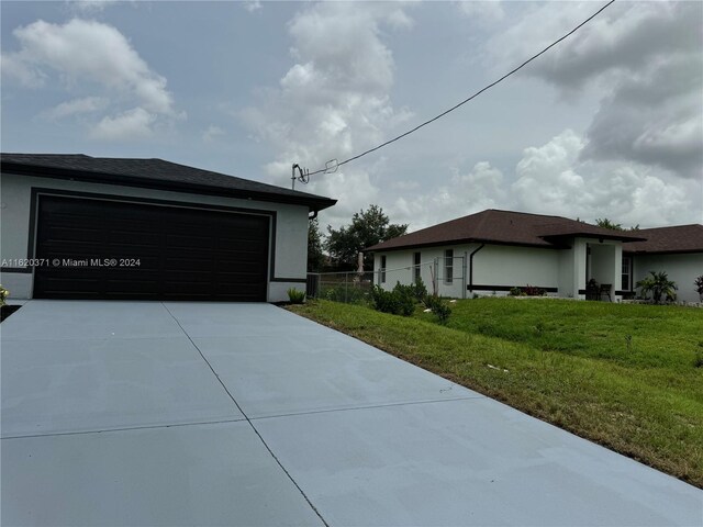 view of side of property with a garage and a yard