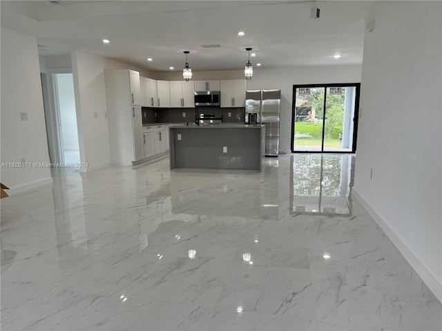 kitchen with white cabinetry, light tile patterned floors, a kitchen island with sink, stainless steel appliances, and decorative light fixtures