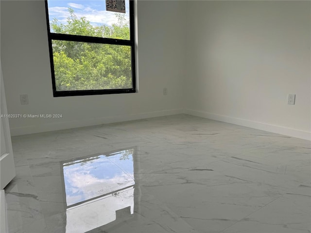 unfurnished room with tile patterned floors