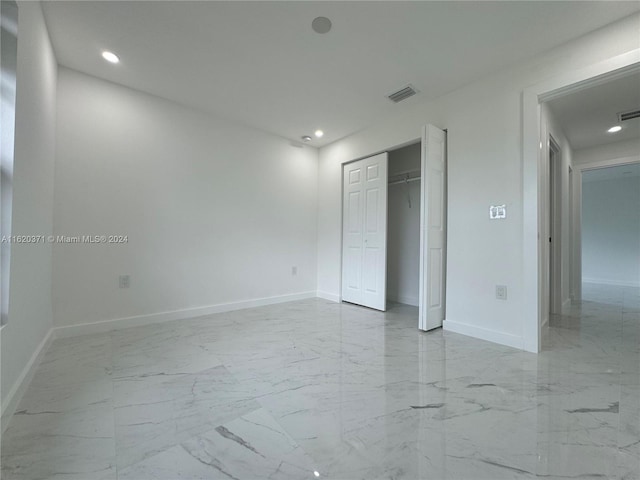 unfurnished bedroom featuring light tile patterned flooring and a closet