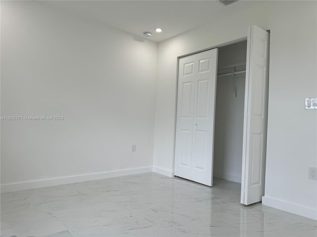 unfurnished bedroom with a closet