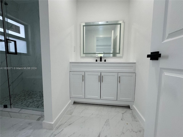 bathroom with tiled shower, vanity, tile patterned floors, and plenty of natural light