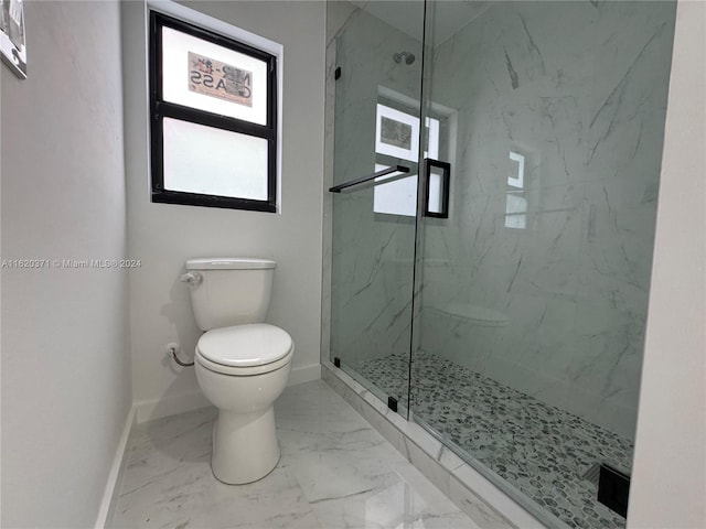 bathroom featuring toilet, a shower with door, and tile patterned flooring