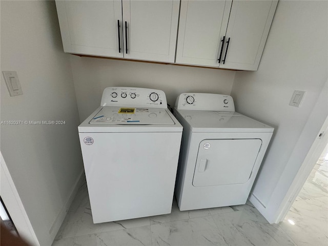 laundry room featuring cabinets and independent washer and dryer