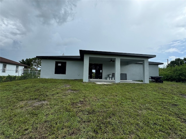 back of house with a patio area, a lawn, and ceiling fan