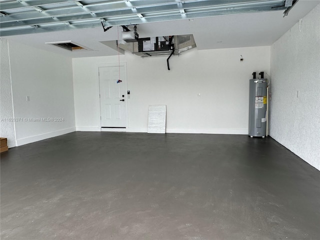 garage with electric water heater and a garage door opener