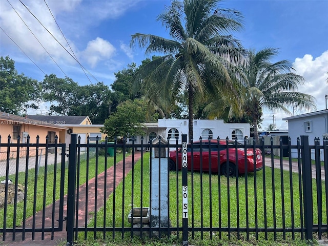 view of gate featuring a yard