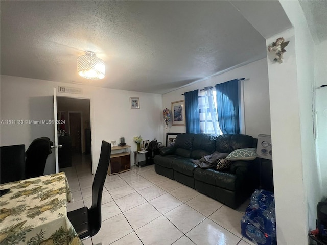 tiled living room with a textured ceiling