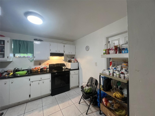 kitchen featuring white cabinetry, sink, light tile patterned floors, and black electric range