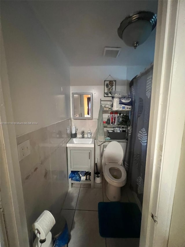 bathroom with vanity, tile patterned flooring, and toilet