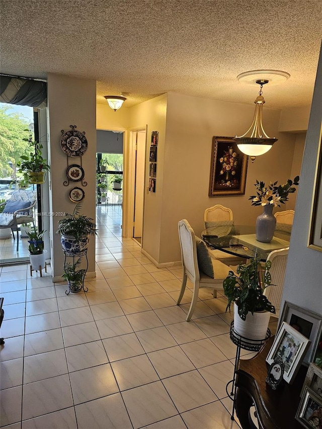 unfurnished dining area with light tile patterned flooring and a textured ceiling