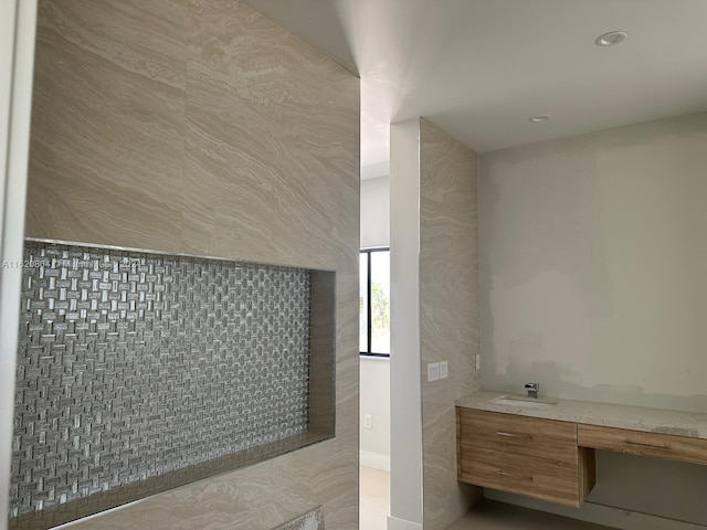 bathroom featuring tile walls and vanity