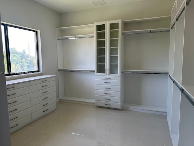 spacious closet with light tile patterned floors