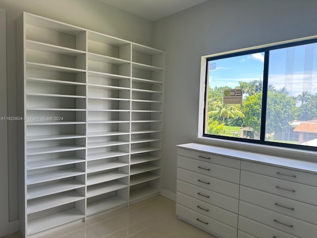 spacious closet with light tile patterned flooring