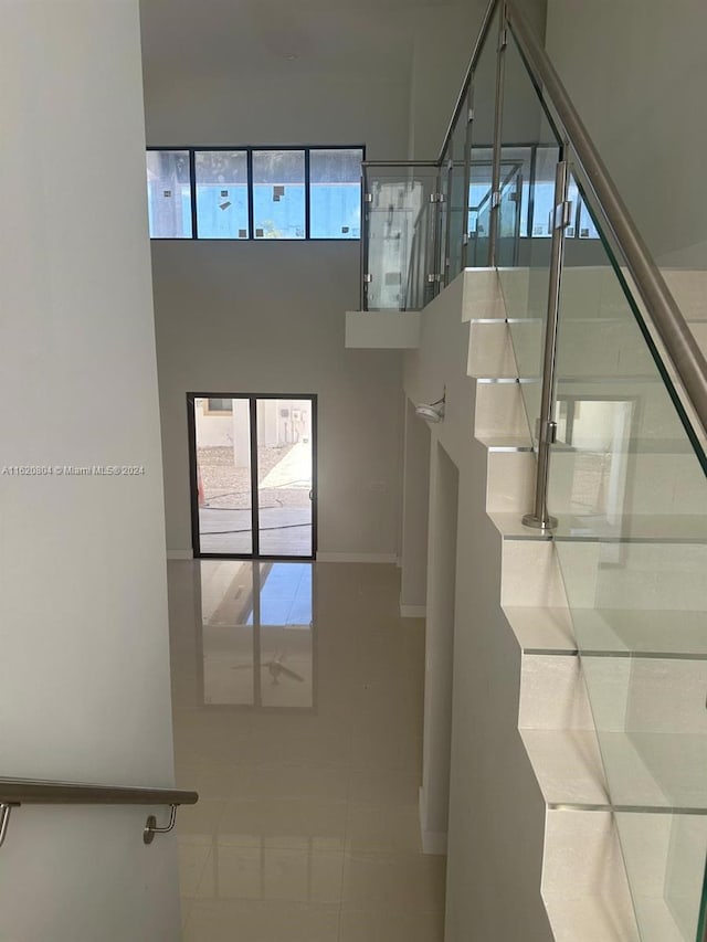 stairs featuring a healthy amount of sunlight and tile patterned floors